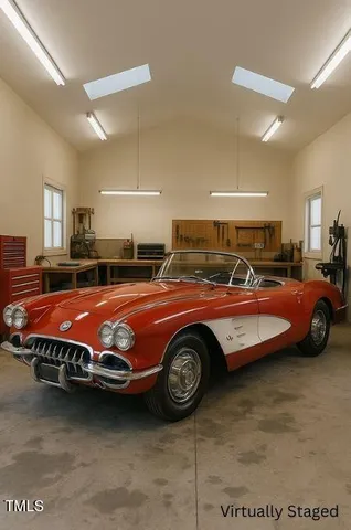 a bed sitting in a room next to a lamp