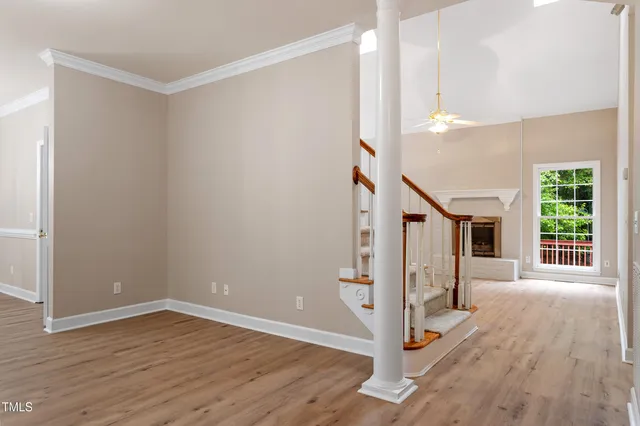 a view of a livingroom with wooden floor and stairs