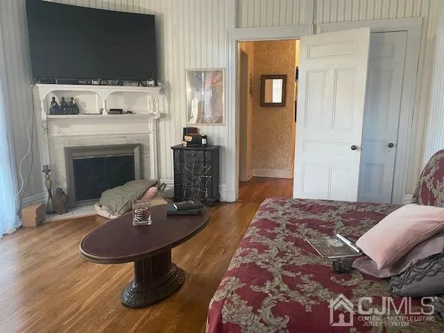 a bedroom with a bed and a potted plant