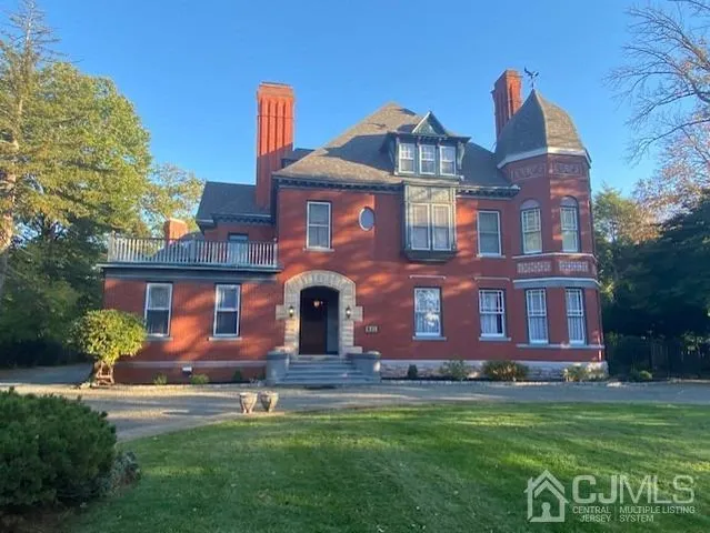 a living room with a fireplace furniture and a large window