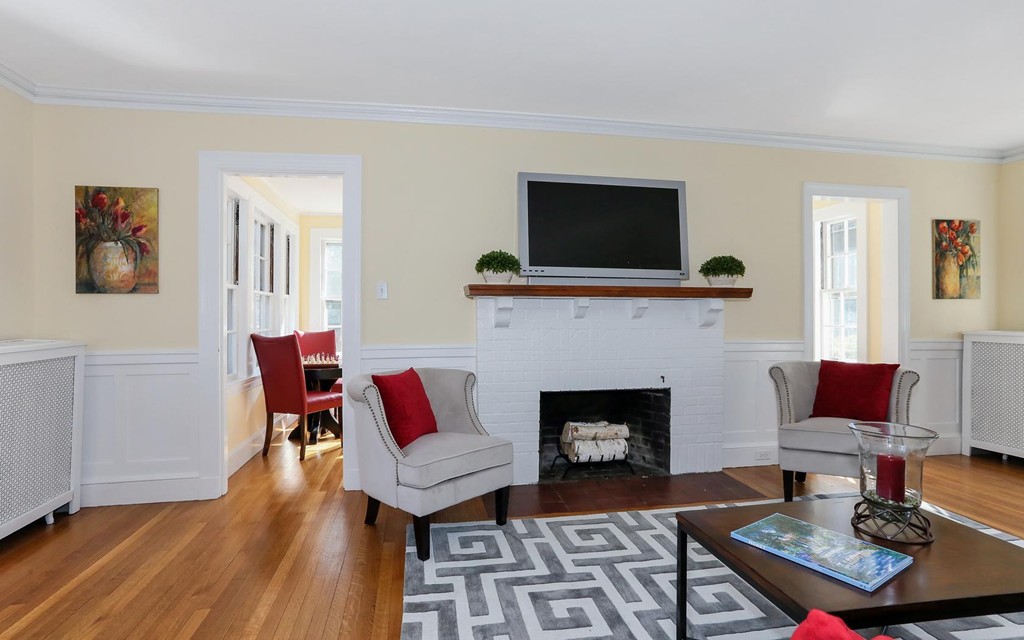 56 Nehoiden Road Newton, MA 02468 - Photo 7 of 28 a living room with furniture a flat screen tv and a fireplace