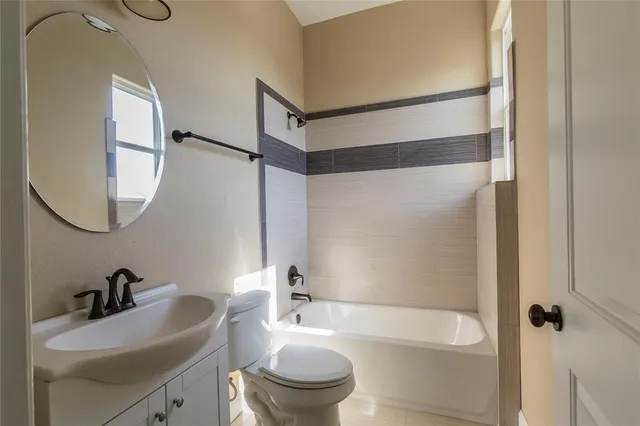 a bathroom with a sink a toilet and a mirror