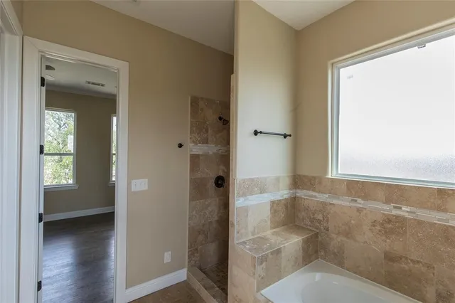 a bathroom with a granite countertop shower and a sink