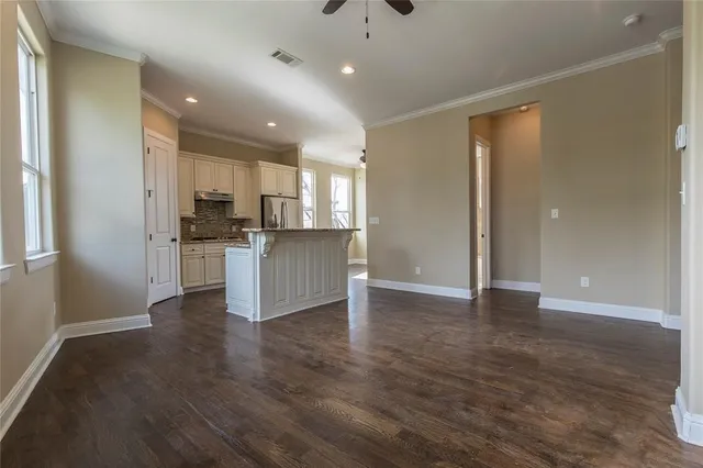 a view of kitchen with refrigerator and window