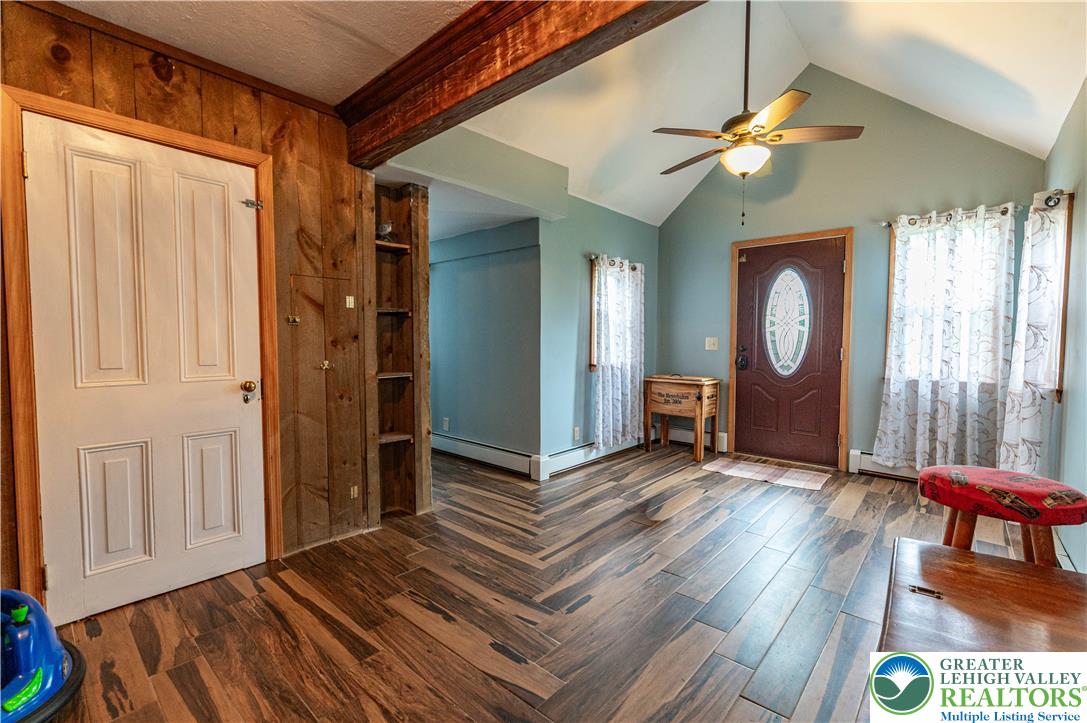 2485 Hieter Road Quakertown, PA 18951 - Photo 6 of 97 Herringbone-patterned hardwood floors grace the welcoming entry with a soaring vaulted ceiling.