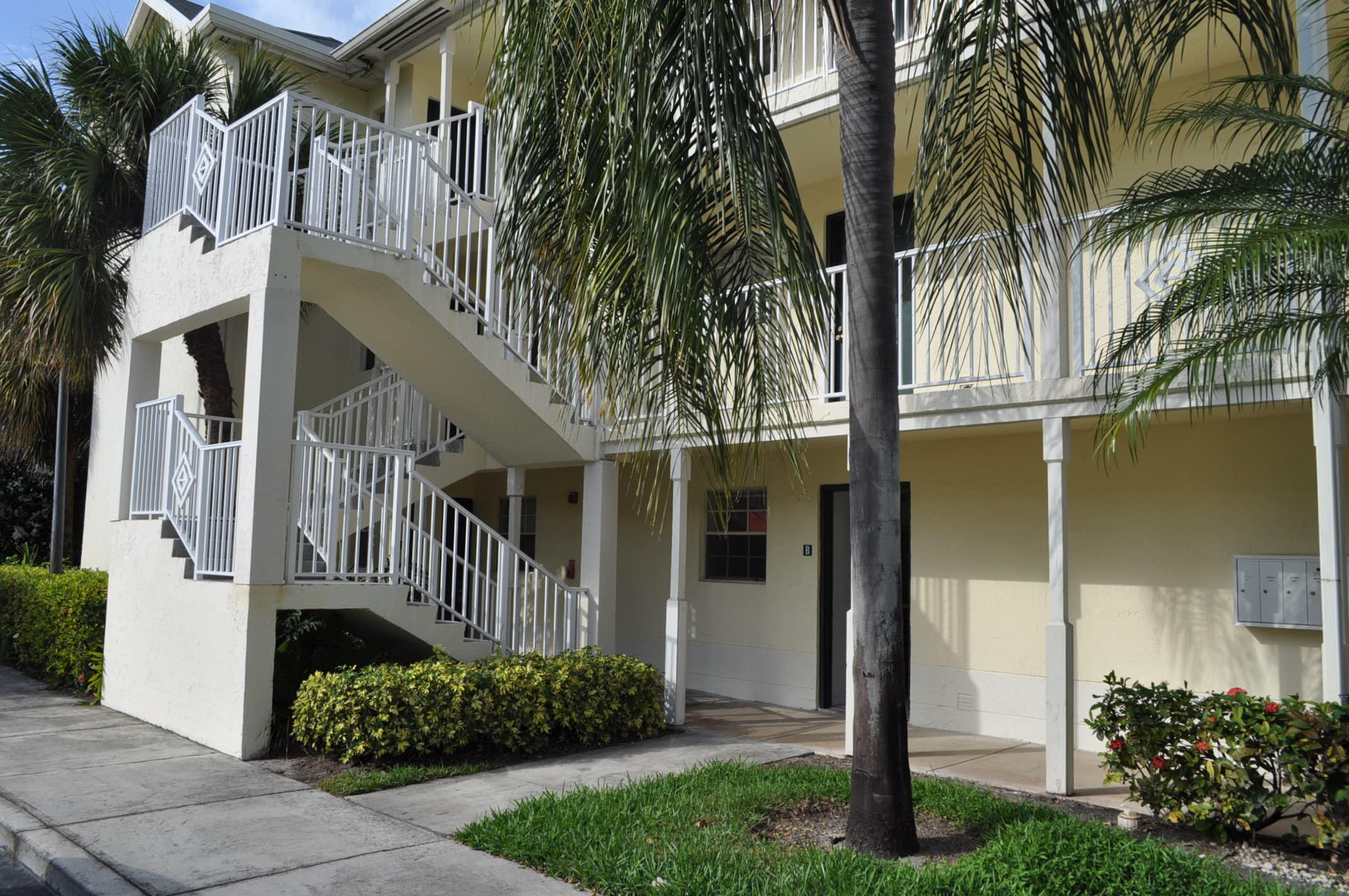 6284 La Costa Drive, Unit B Boca Raton, FL 33433 - Photo 2 of 8 a view of a house with a small yard and plants