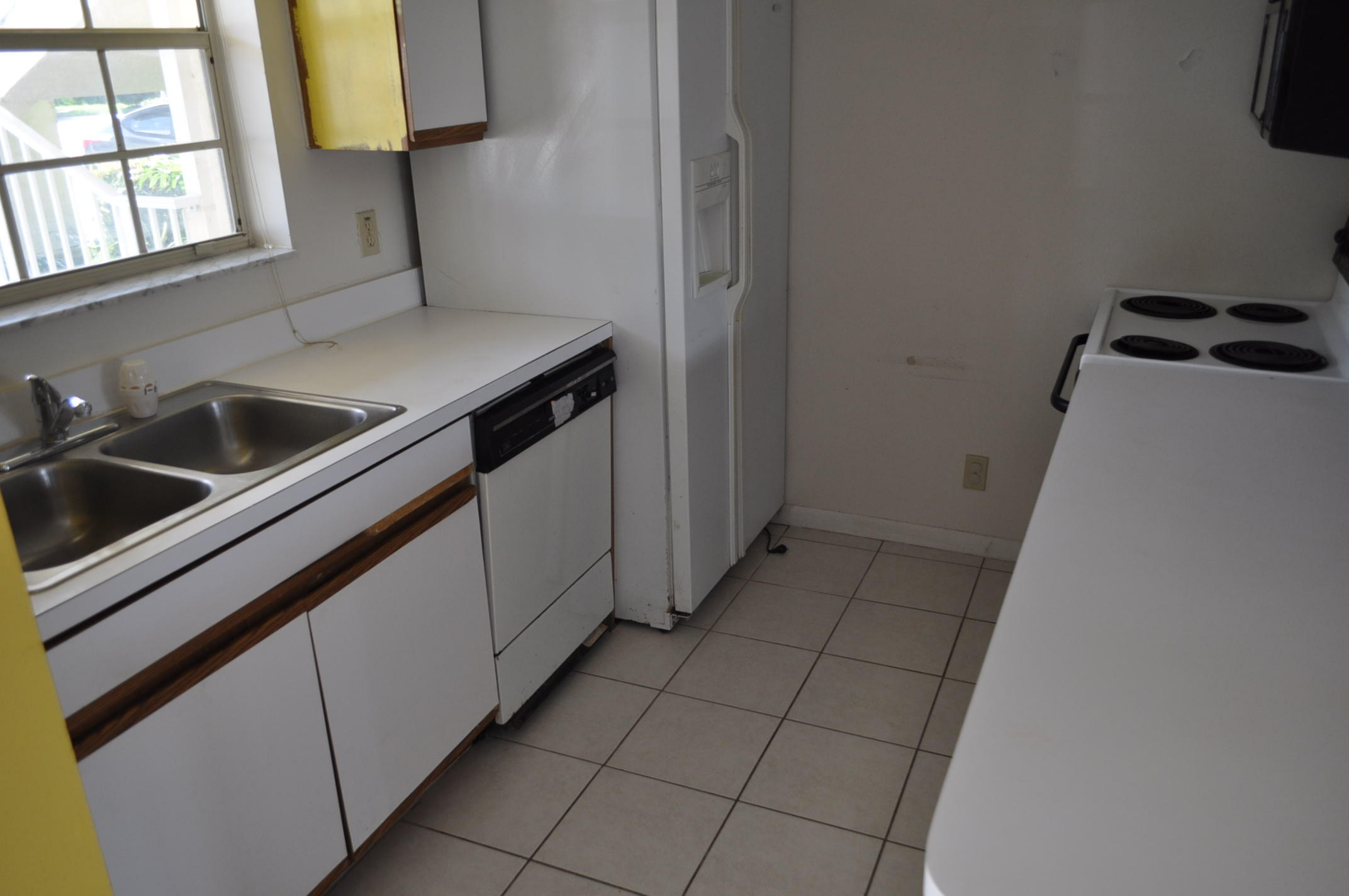 6284 La Costa Drive, Unit B Boca Raton, FL 33433 - Photo 3 of 8 a kitchen with a sink a stove and cabinets