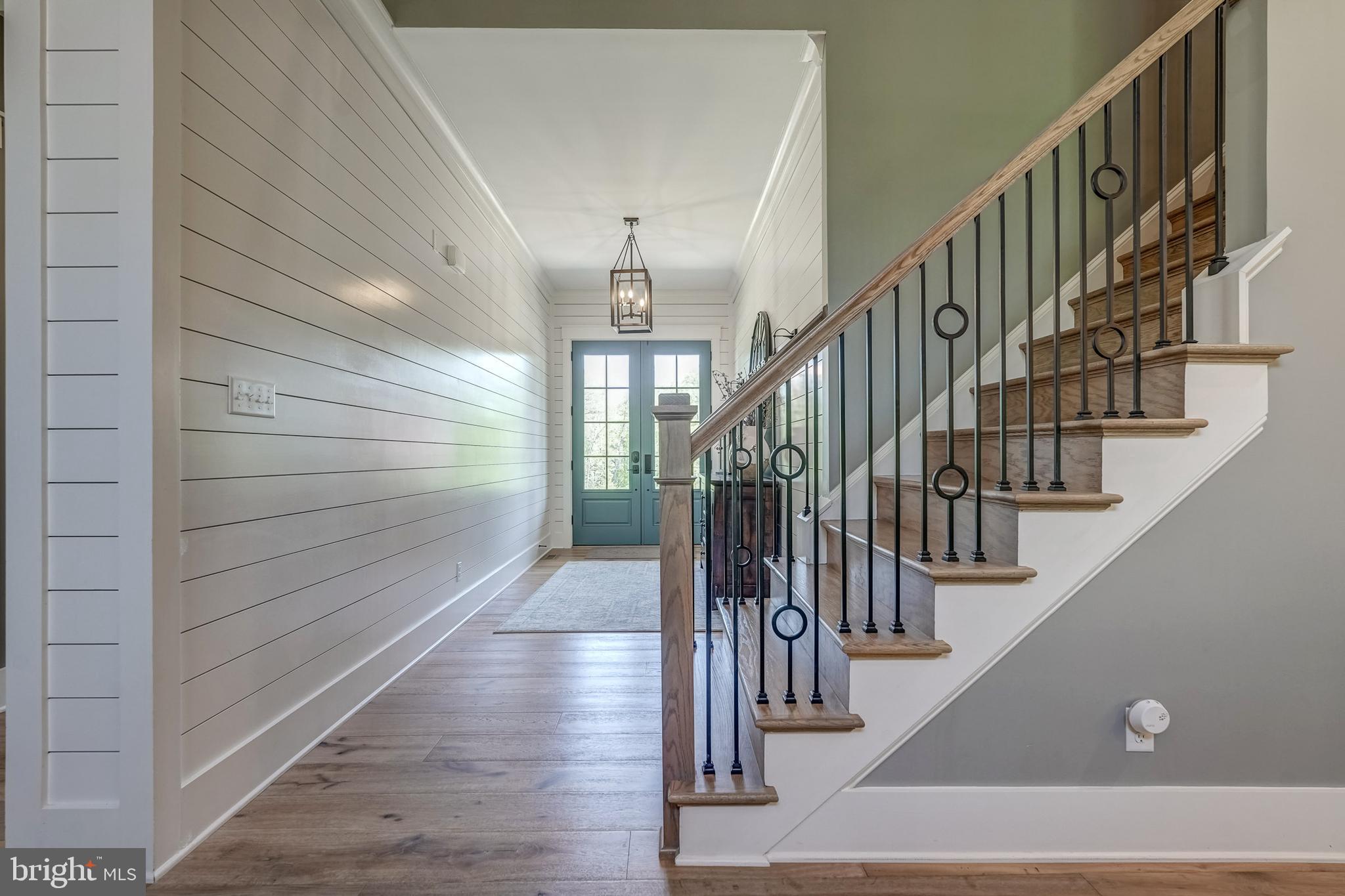 13325 Kelham Road Midlothian, VA 23113 - Photo 54 of 109 a view of staircase with lots of frames on wall and wooden floor