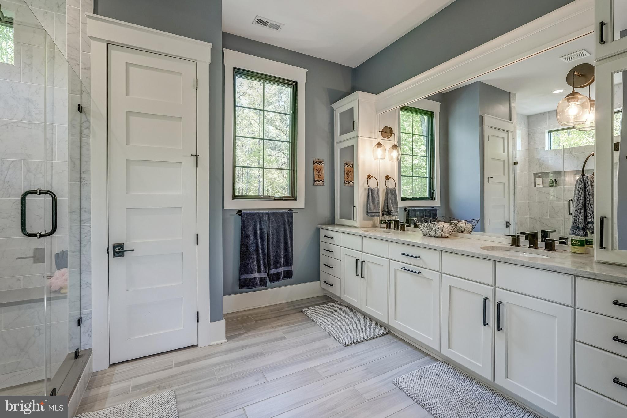 13325 Kelham Road Midlothian, VA 23113 - Photo 65 of 109 a spacious bathroom with a double vanity sink a large mirror and a shower