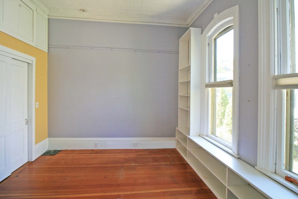 76 Crescent Street, Unit 2 Northampton, MA 01060 - Photo 12 of 25 a view of an empty room with a window and wooden floor
