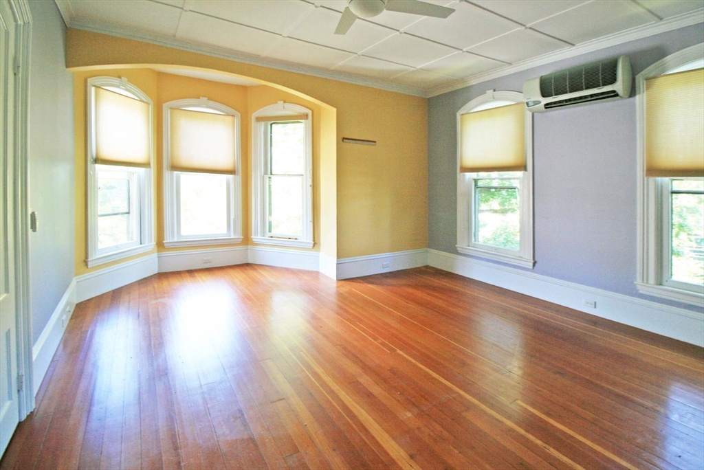 76 Crescent Street, Unit 2 Northampton, MA 01060 - Photo 19 of 25 a view of an empty room with wooden floor and a window