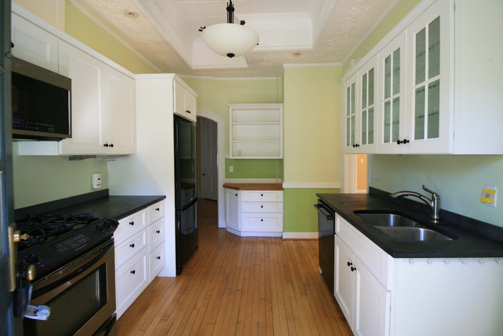 76 Crescent Street, Unit 2 Northampton, MA 01060 - Photo 5 of 25 a kitchen with a sink a stove and cabinets