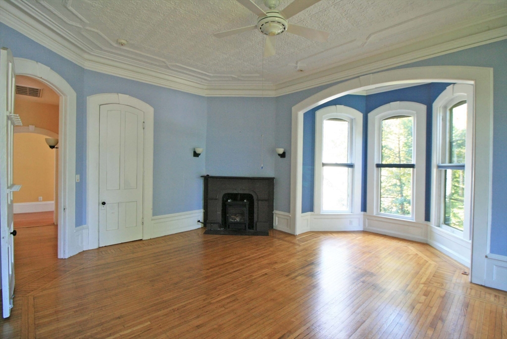 76 Crescent Street, Unit 2 Northampton, MA 01060 - Photo 9 of 25 a view of an empty room with window and fire place