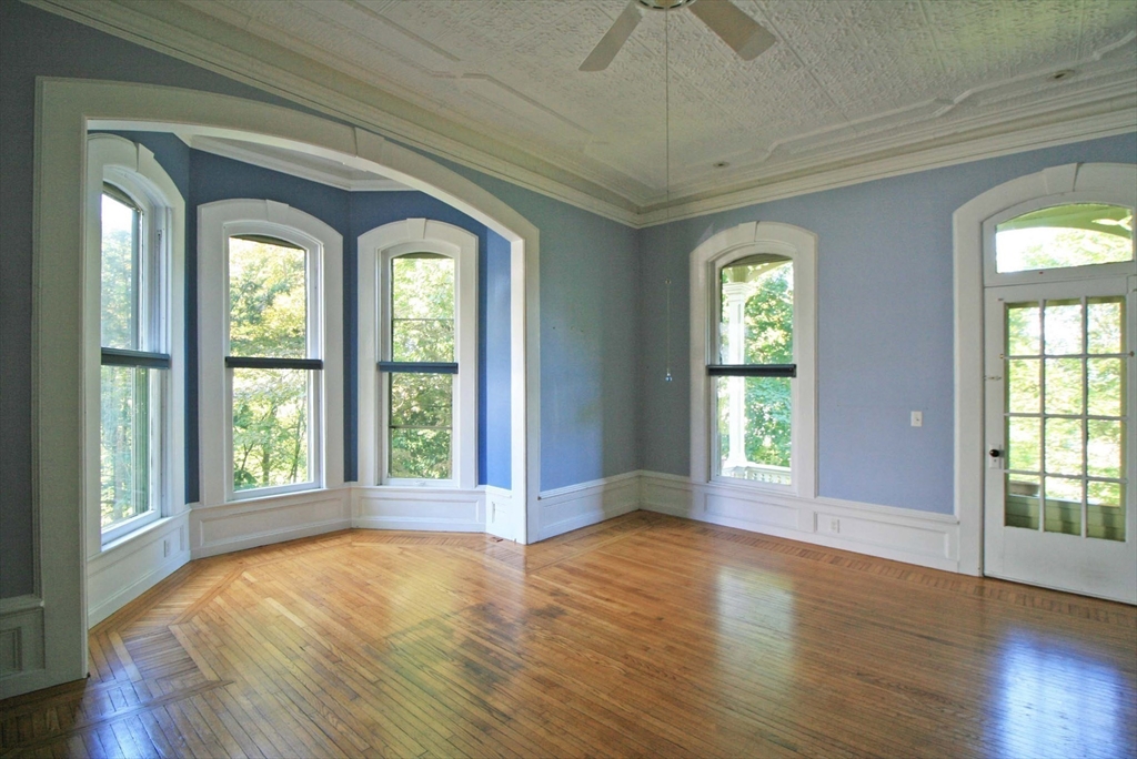 76 Crescent Street, Unit 2 Northampton, MA 01060 - Photo 10 of 25 a view of an empty room with wooden floor and a window