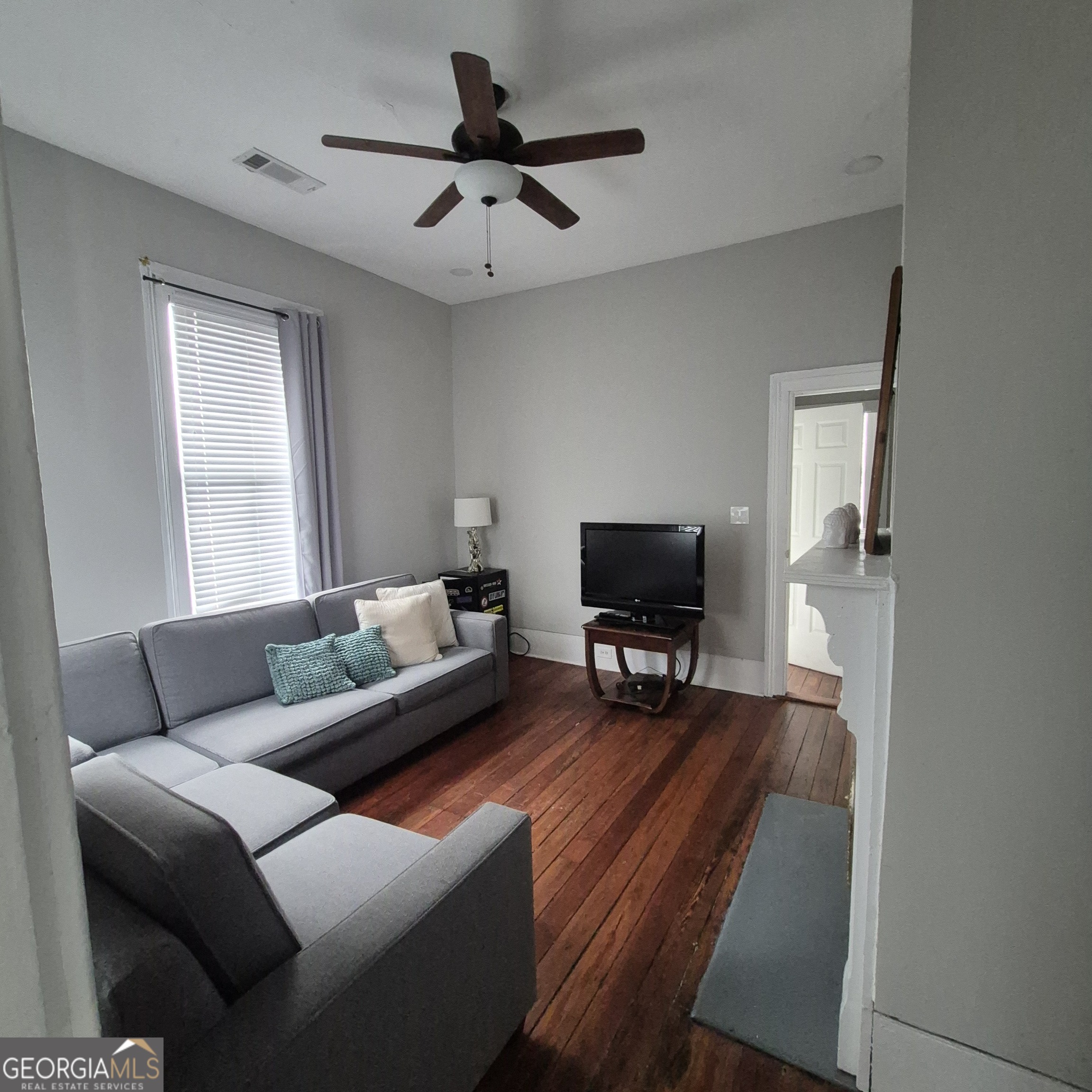 867 Orange Terrace, Unit B Macon, GA 31201 - Photo 11 of 14 a living room with furniture and a flat screen tv