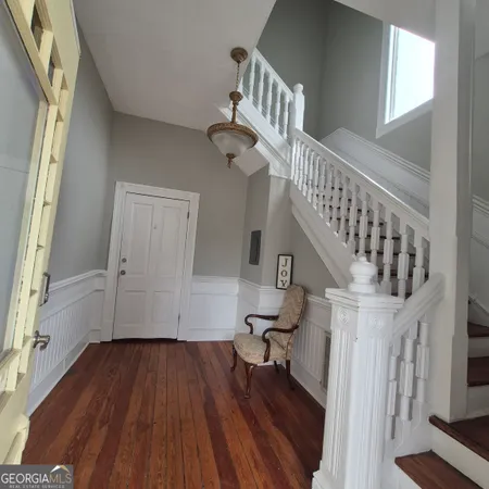 a view of entryway with wooden floor and stairs