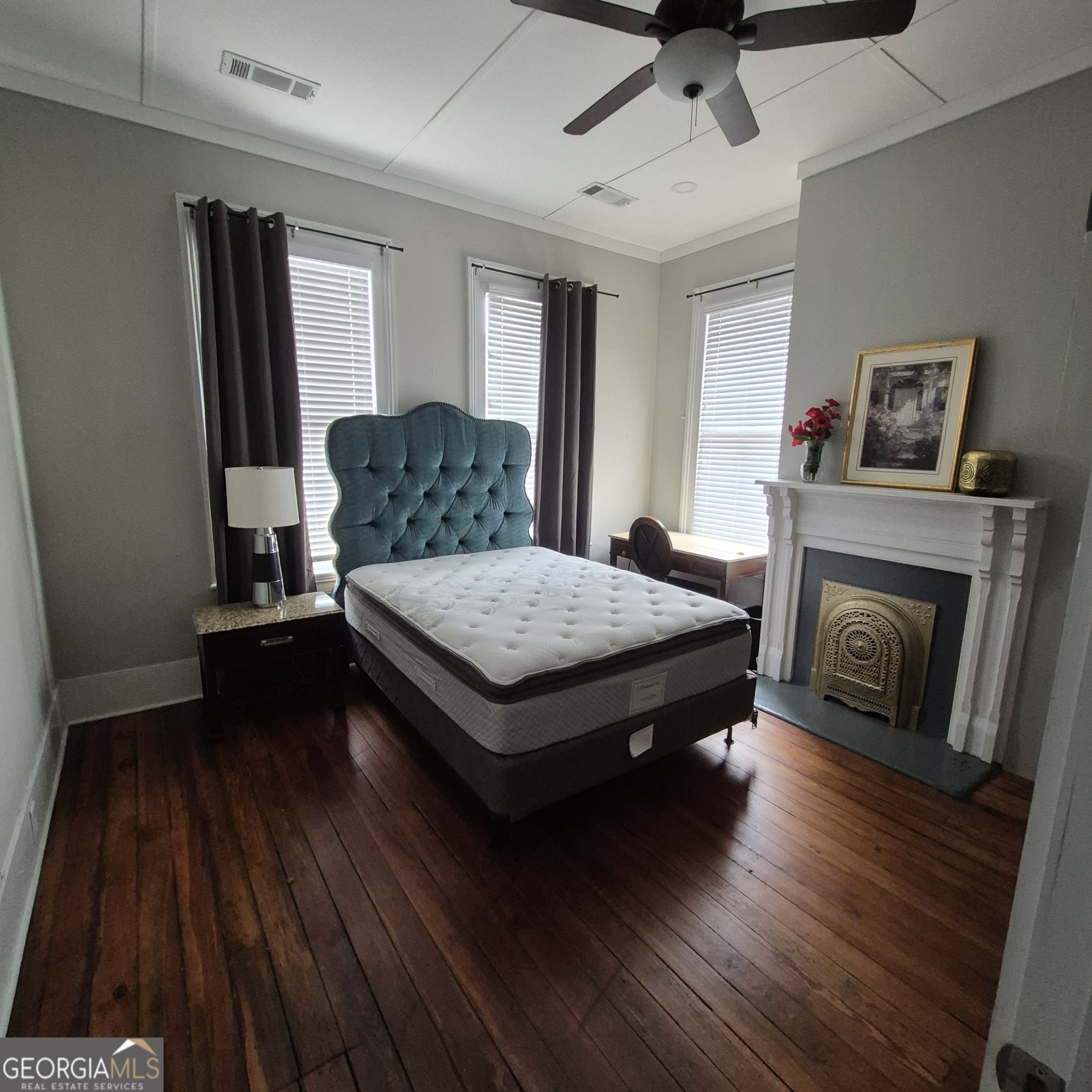 867 Orange Terrace, Unit B Macon, GA 31201 - Photo 6 of 14 a living room with a bed and a fireplace