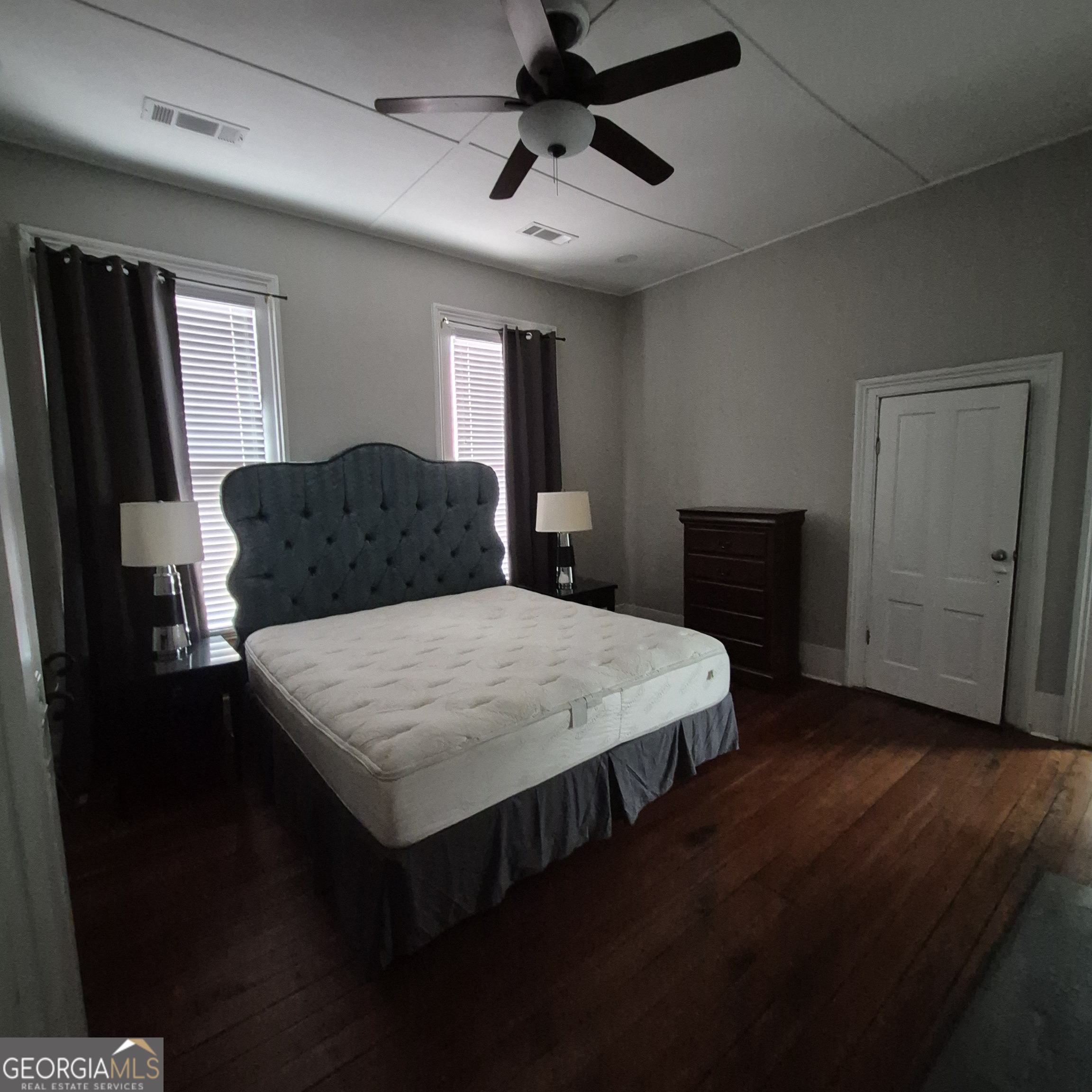 867 Orange Terrace, Unit B Macon, GA 31201 - Photo 8 of 14 a bedroom with a bed and a chandelier
