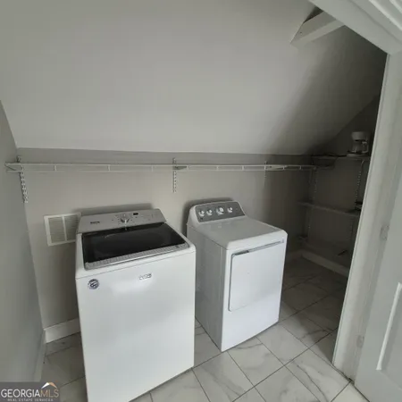 a utility room with dryer and washer