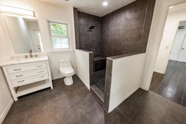 a bathroom with a toilet sink and a mirror