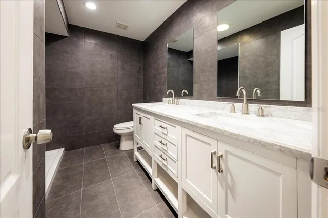 a bathroom with a double vanity sink and a mirror