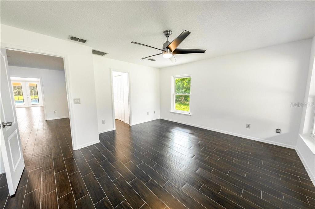3443 Wild Myrtle Court Windermere, FL 34786 - Photo 21 of 32 wooden floor in an empty room with a window