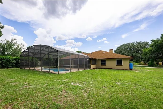 a view of a house with a yard and sitting area