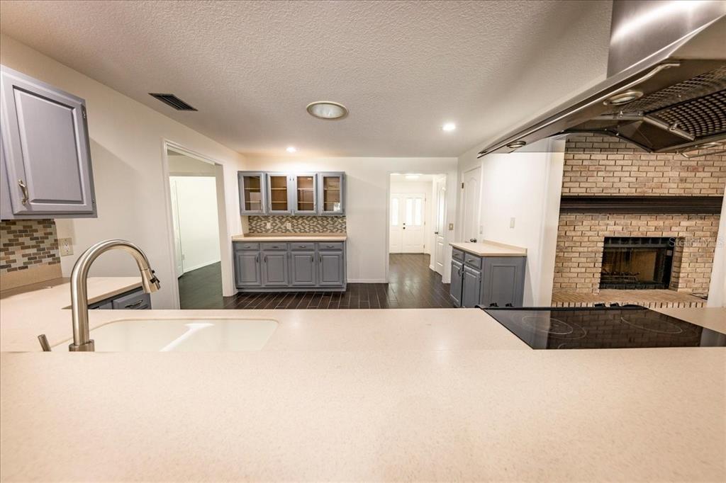 3443 Wild Myrtle Court Windermere, FL 34786 - Photo 5 of 32 a kitchen with stainless steel appliances kitchen island a sink a stove and cabinets
