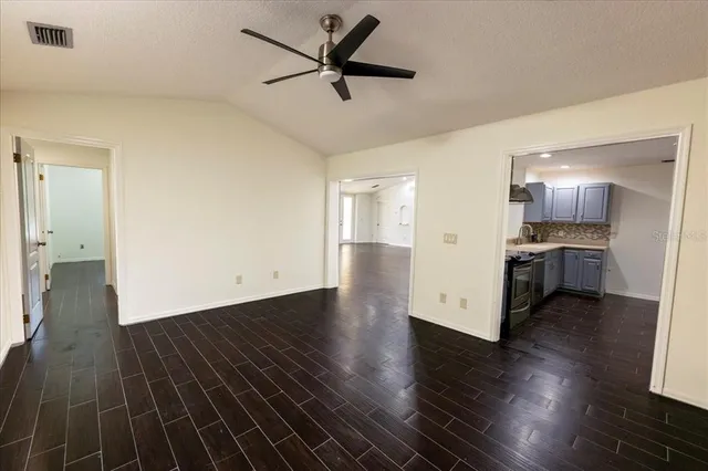 a view of a kitchen with stove and wooden floor