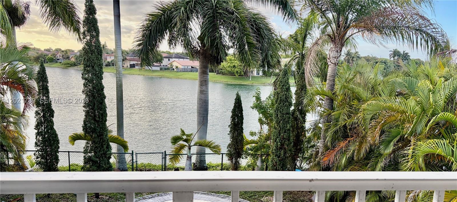 13553 Southwest 124th Avenue Road Miami, FL 33186 - Photo 31 of 31 a view of a lake from a window and a palm tree