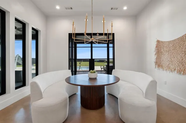 a dining room with furniture a window and a chandelier