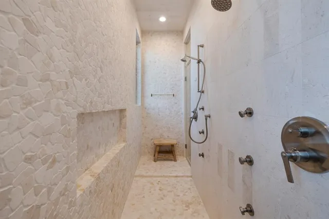 a bathroom with a granite countertop shower