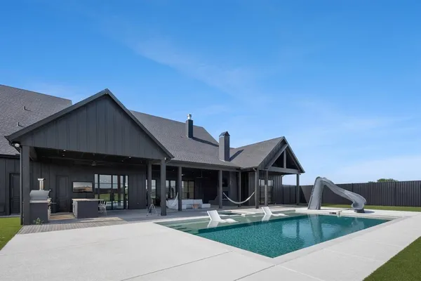 a backyard of a house with table and chairs