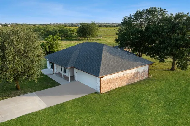 a front view of house with yard barbeque oven and outdoor seating