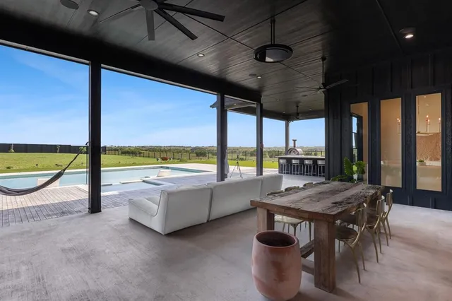a view of a swimming pool and outdoor seating