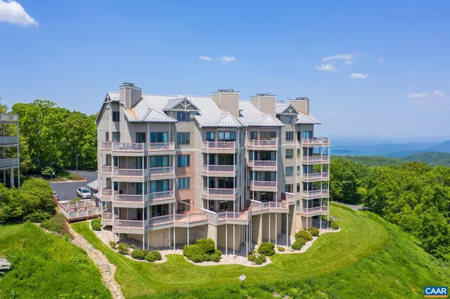 a front view of a residential apartment building with a yard