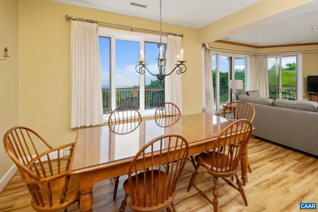 a dining room with furniture water view and balcony