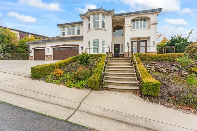 a view of a house with backyard porch and sitting area