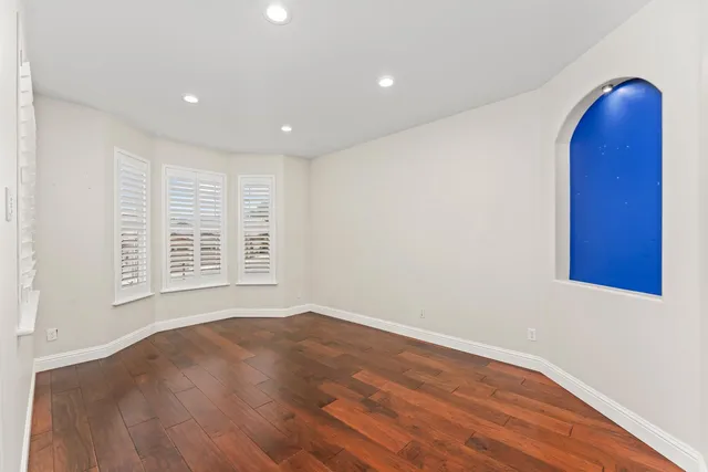 a large kitchen with granite countertop a sink window and cabinets