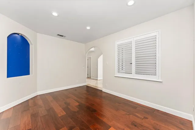 a spacious bathroom with a granite countertop sink and mirror