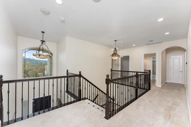 an empty room with a ceiling fan and windows