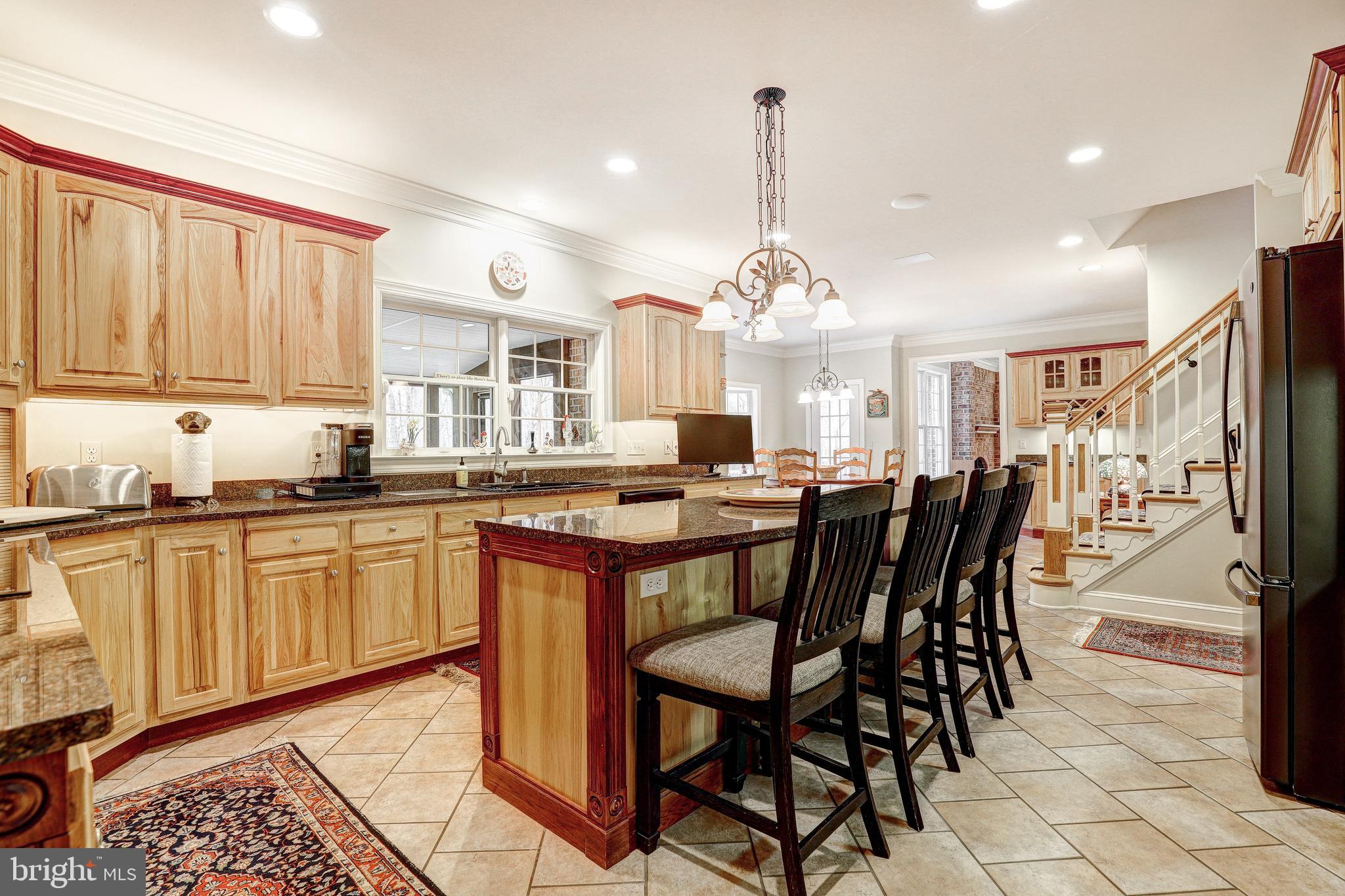 17420 Wesley Chapel Road Monkton, MD 21111 - Photo 17 of 76 a open kitchen with stainless steel appliances granite countertop a stove a sink dishwasher a dining table and chairs with wooden floor
