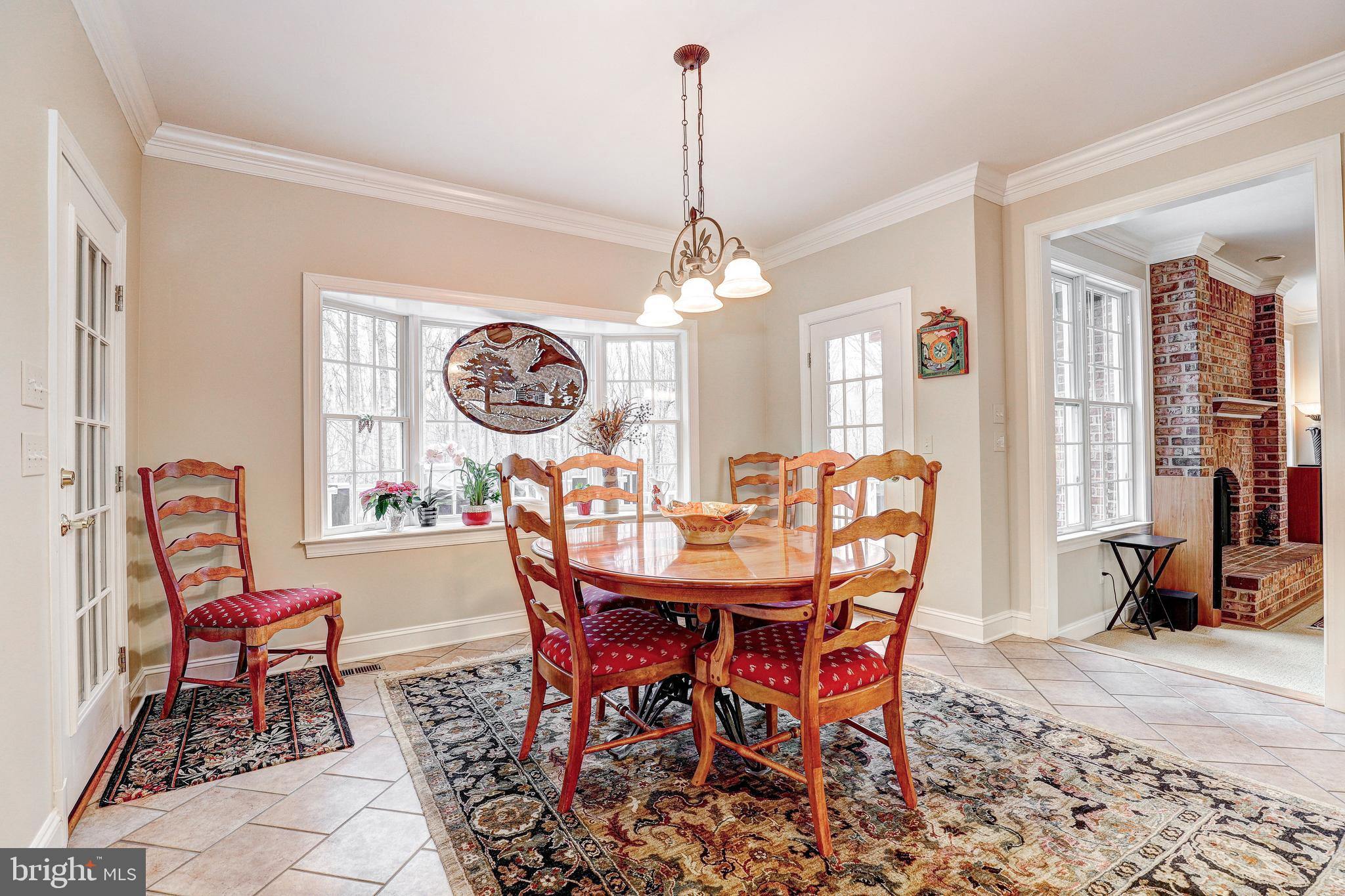17420 Wesley Chapel Road Monkton, MD 21111 - Photo 18 of 76 a dining room with furniture a rug and a chandelier