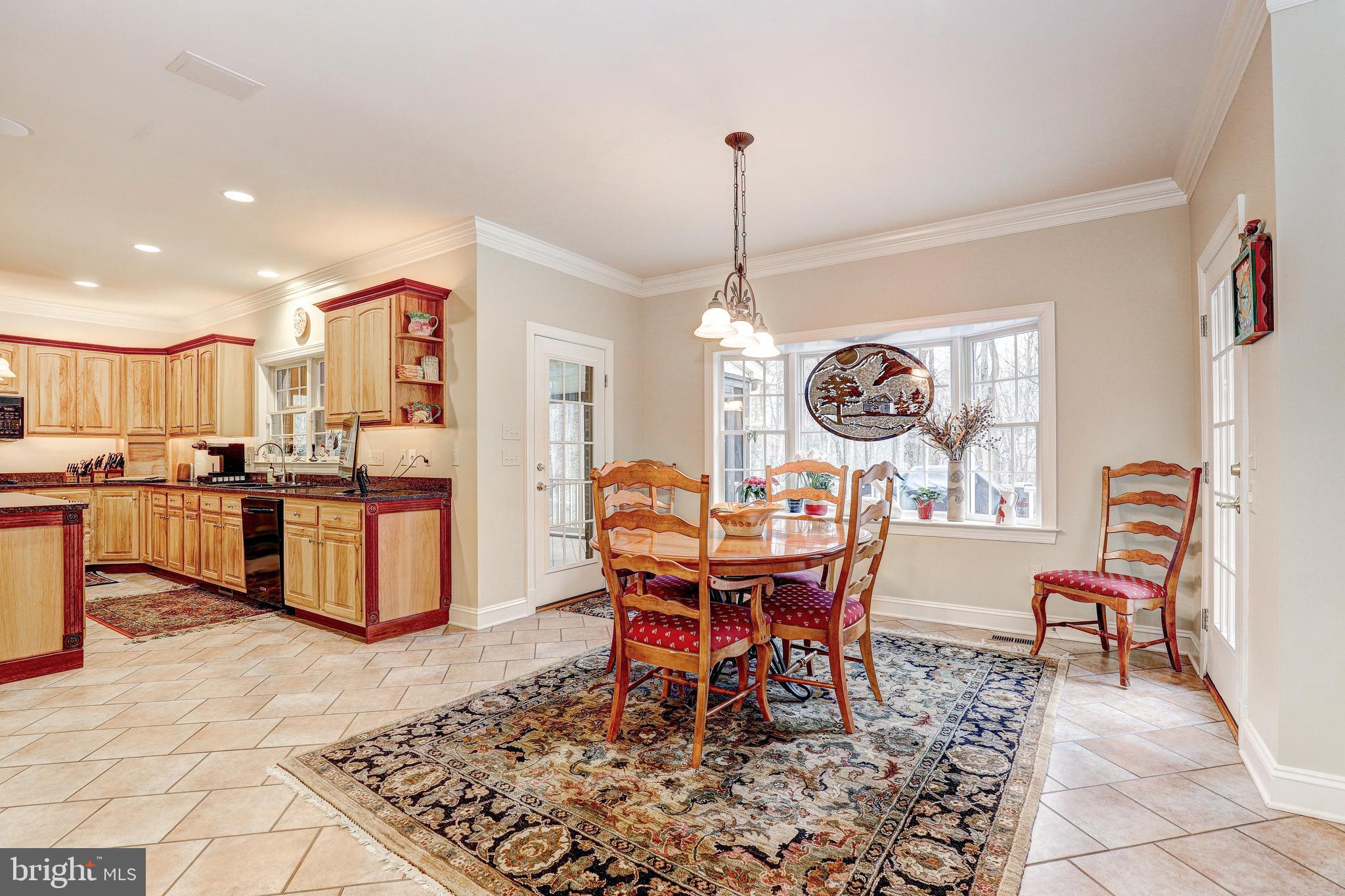 17420 Wesley Chapel Road Monkton, MD 21111 - Photo 19 of 76 a view of a dining room and livingroom with furniture wooden floor and a rug