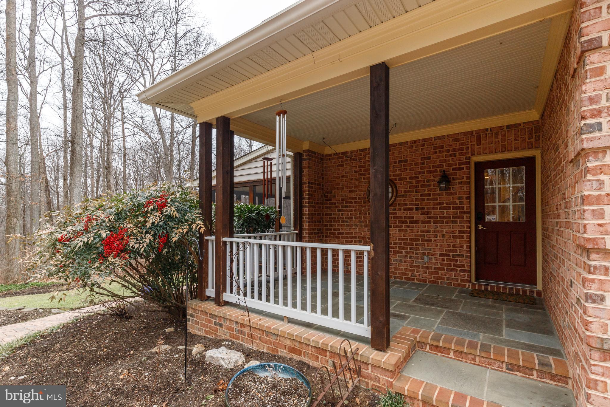 17420 Wesley Chapel Road Monkton, MD 21111 - Photo 52 of 76 a view of a porch with a floor to ceiling window and wooden fence
