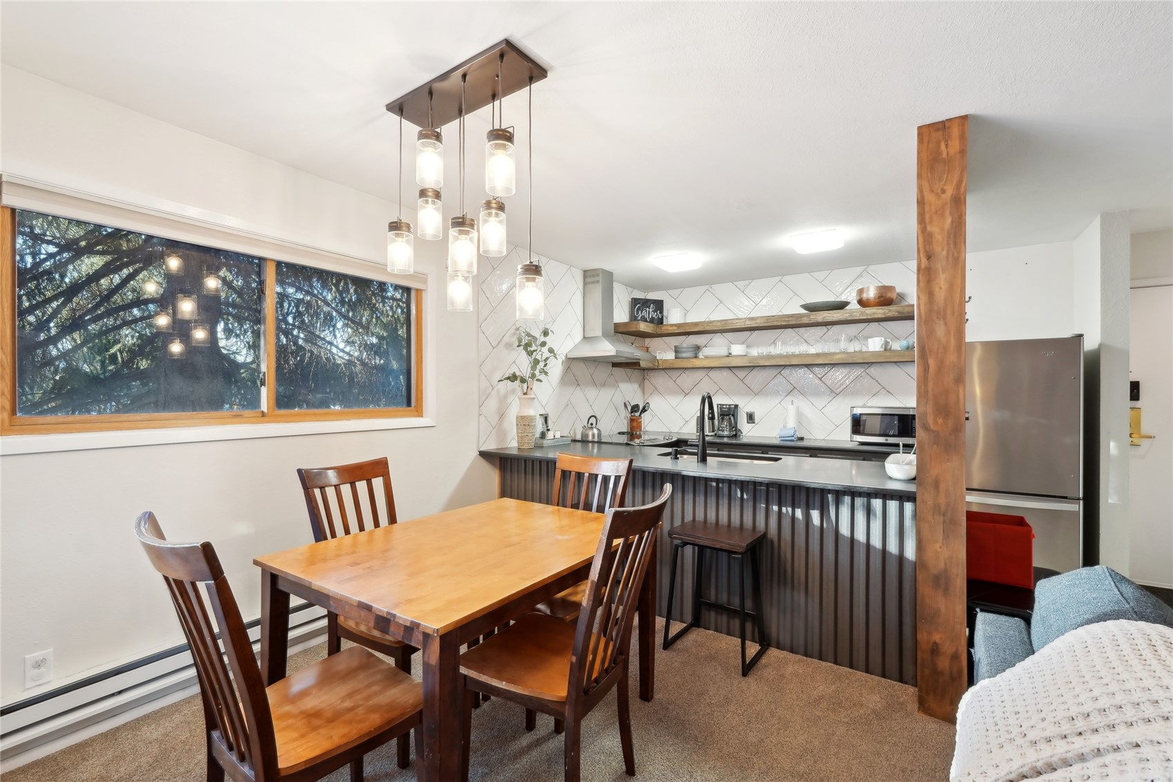 1937 Soda Ridge Road, Unit 1130 Dillon, CO 80435 - Photo 11 of 23 a view of a dining room with furniture window and wooden floor