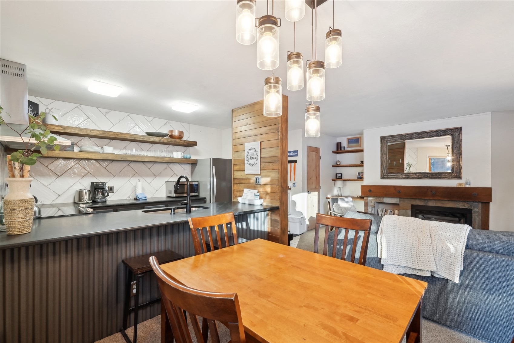 1937 Soda Ridge Road, Unit 1130 Dillon, CO 80435 - Photo 2 of 25 a large kitchen with a table and chairs in it
