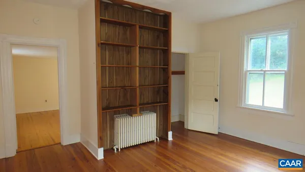 a view of a room with wooden floor and closet