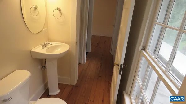 a bathroom with a sink mirror and toilet