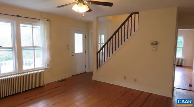 wooden floor in an empty room with a window and wooden floor
